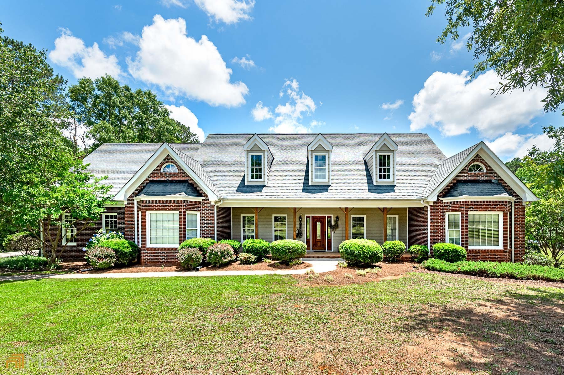 a front view of a house with garden
