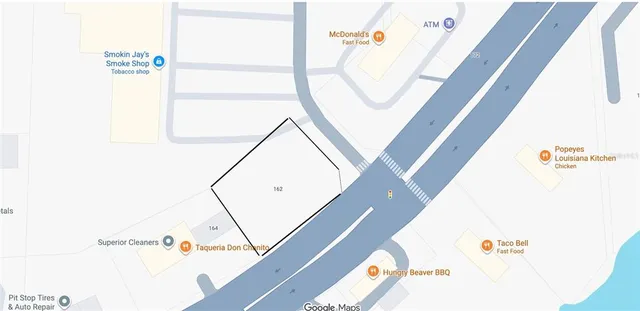 a front view of a building with trees