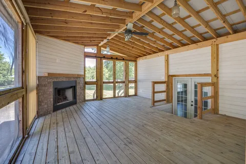 a view of backyard with green space and wooden fence