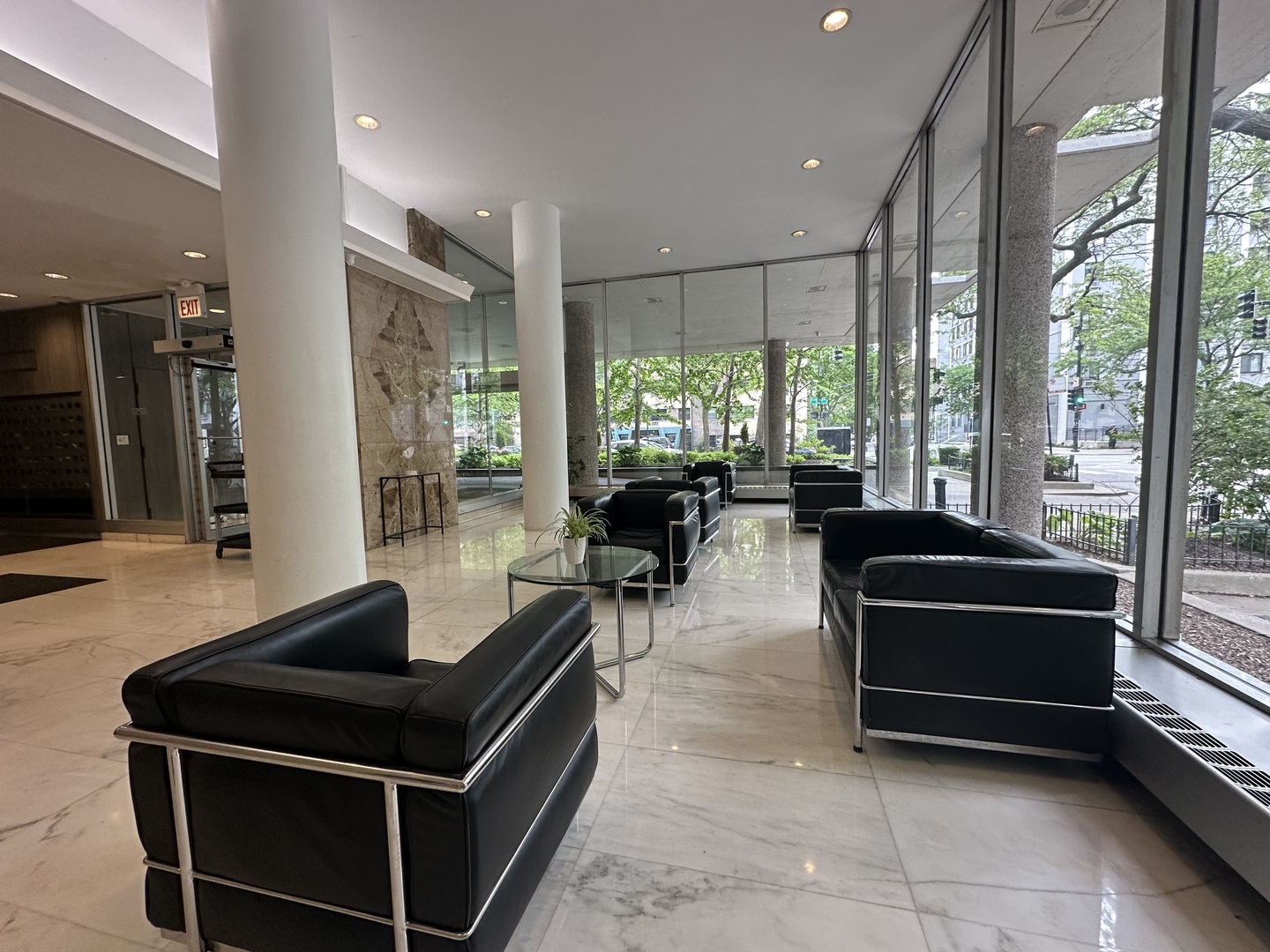 5757 North Sheridan Road, Unit 17H Chicago, IL 60660 - Photo 4 of 25 a living room with furniture a flat screen tv and a large window