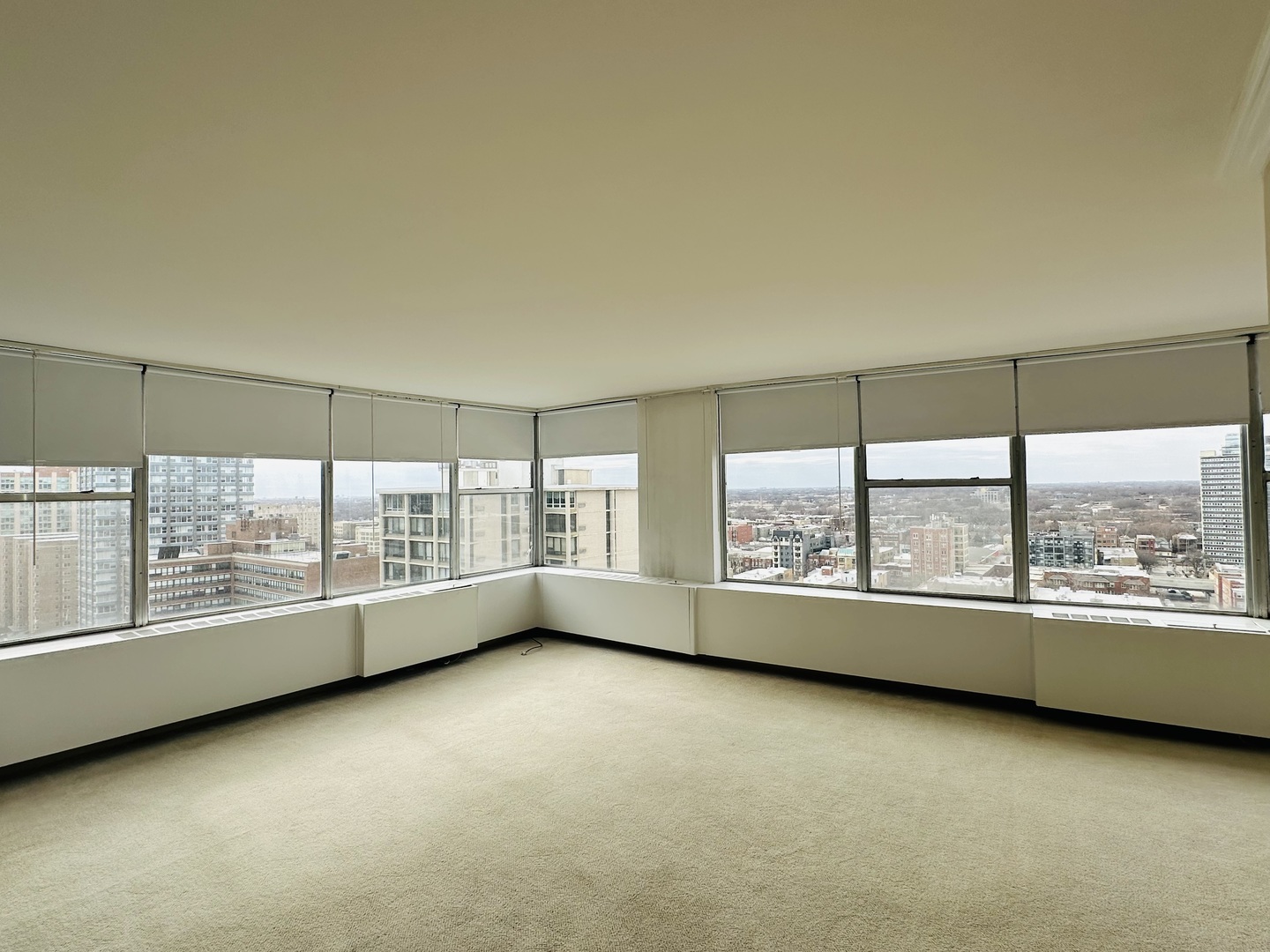 5757 North Sheridan Road, Unit 17H Chicago, IL 60660 - Photo 7 of 25 an empty room with wooden floor and windows with lake view