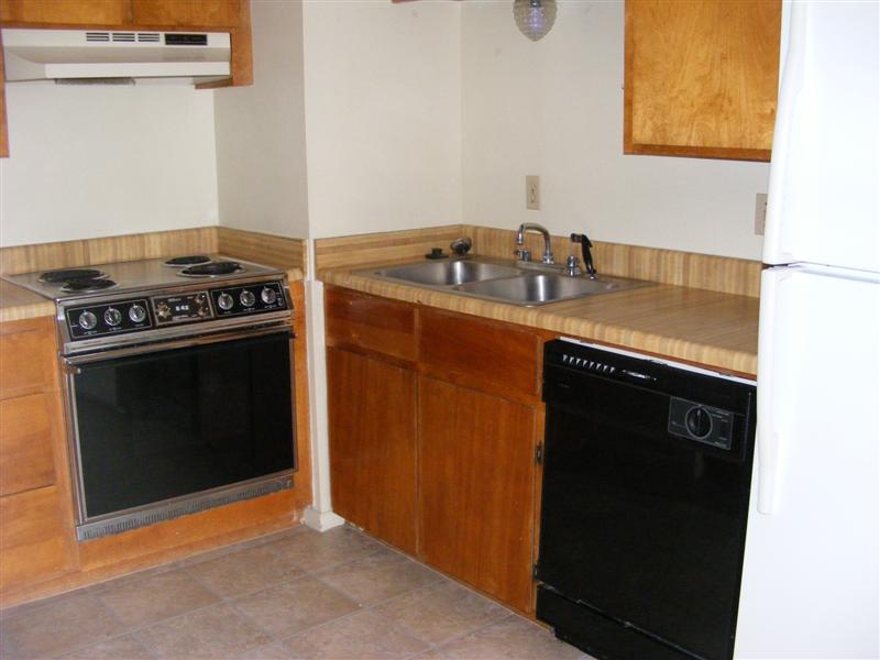 703 Yegua Street, Unit 4 Bryan, TX 77801 - Photo 2 of 10 a kitchen with granite countertop a stove and a sink
