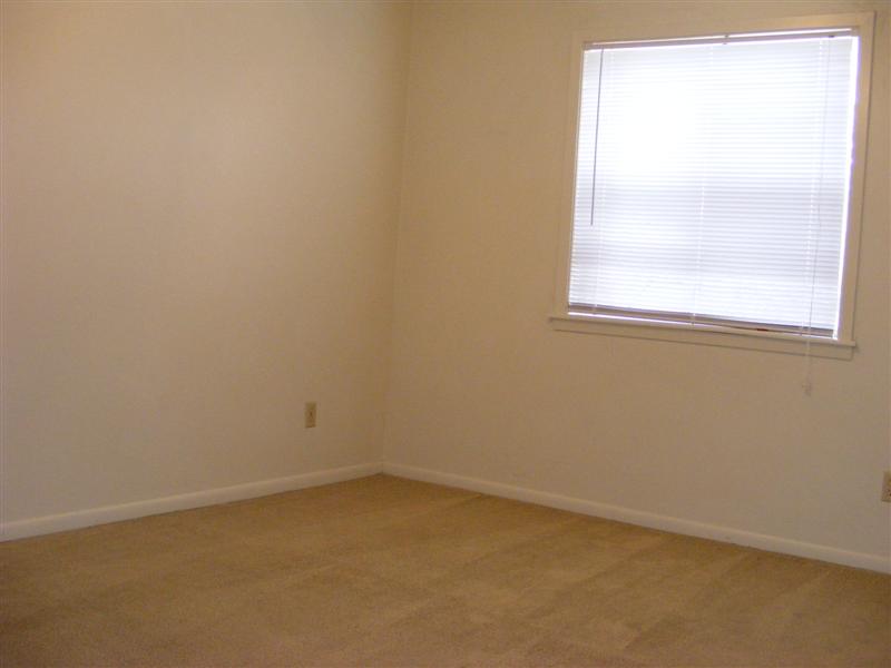 703 Yegua Street, Unit 4 Bryan, TX 77801 - Photo 6 of 10 an empty room with a window