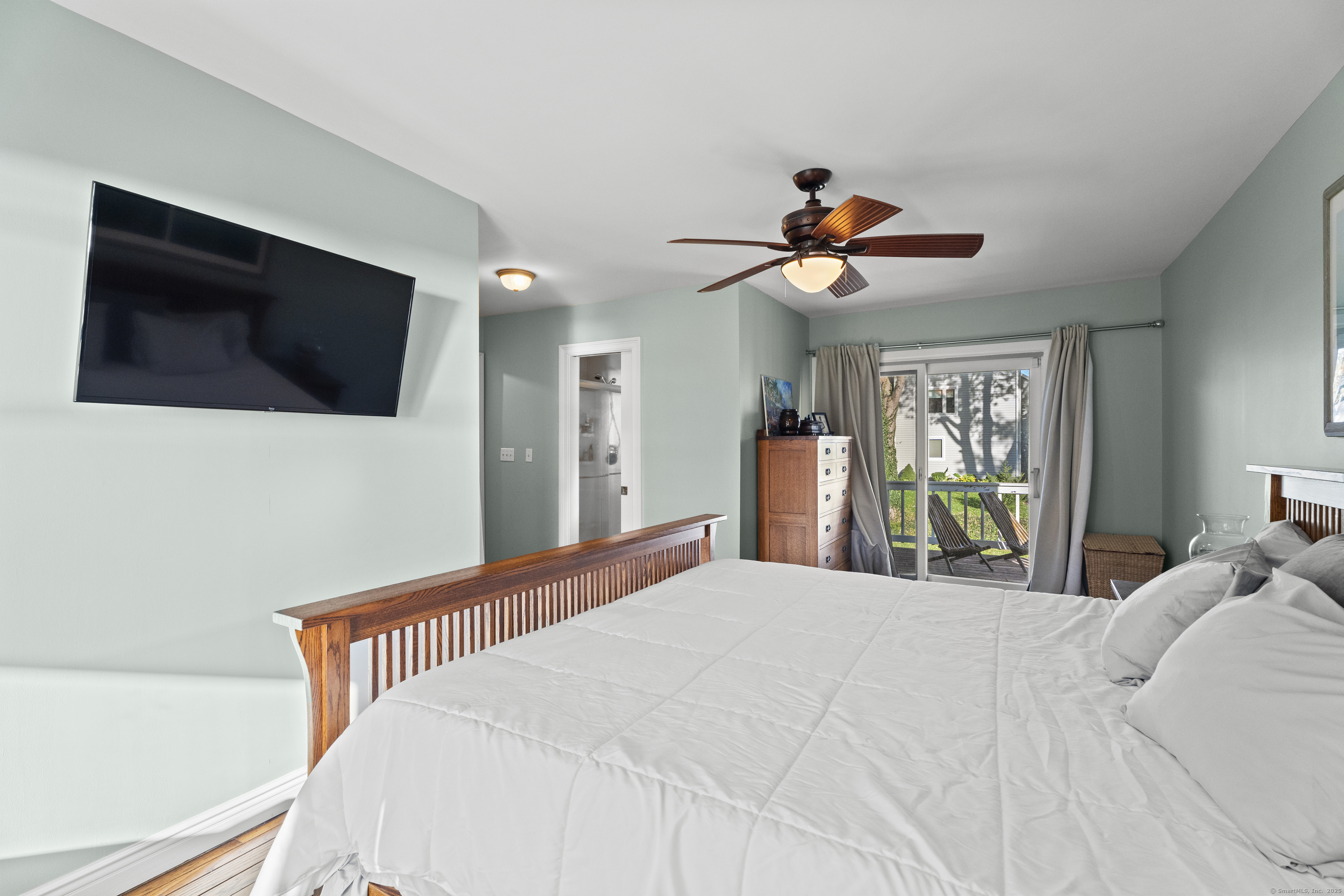 21 Harbor Street Branford, CT 06405 - Photo 22 of 40 a bedroom with a bed and a flat screen tv