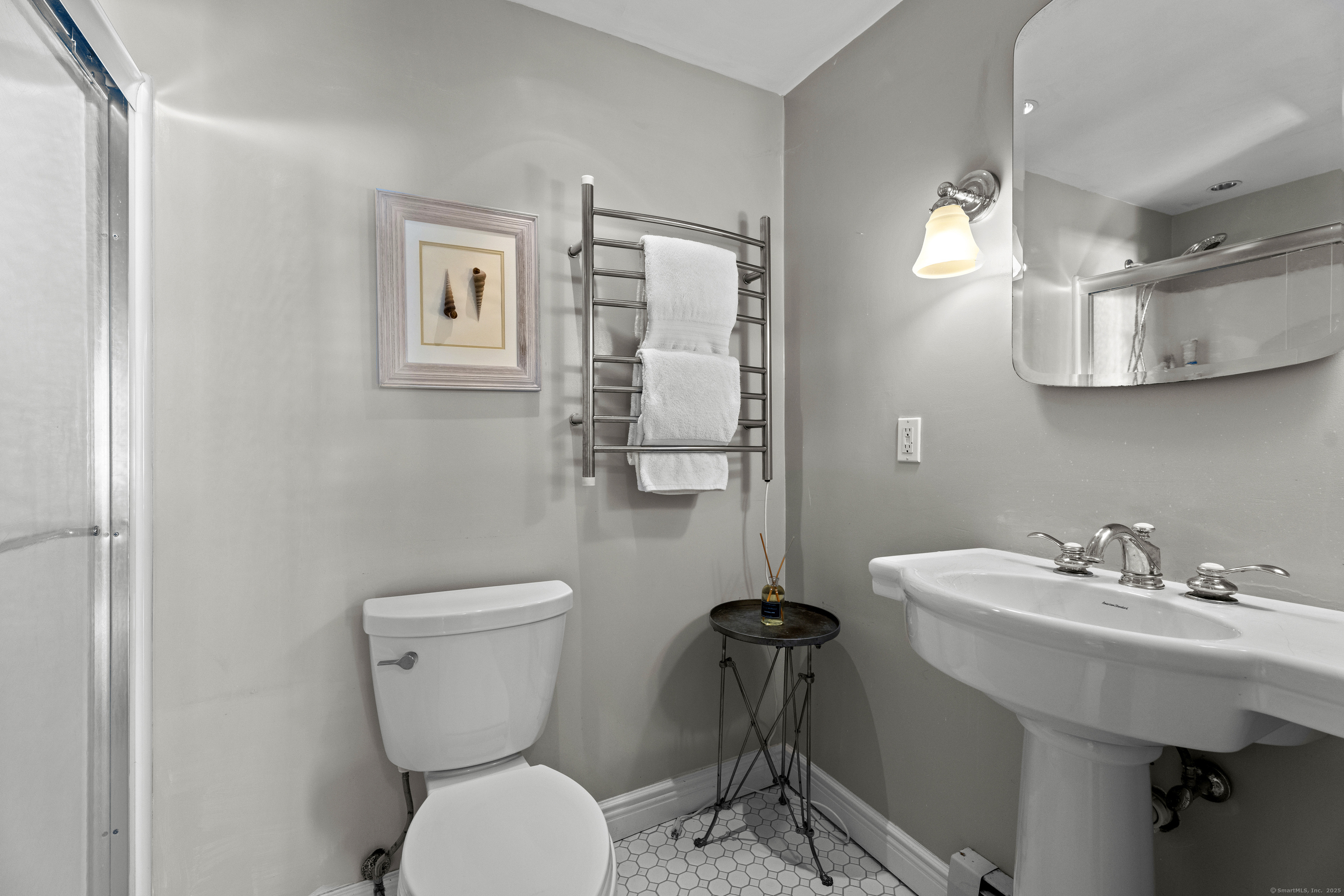 21 Harbor Street Branford, CT 06405 - Photo 24 of 40 a bathroom with a toilet sink and mirror