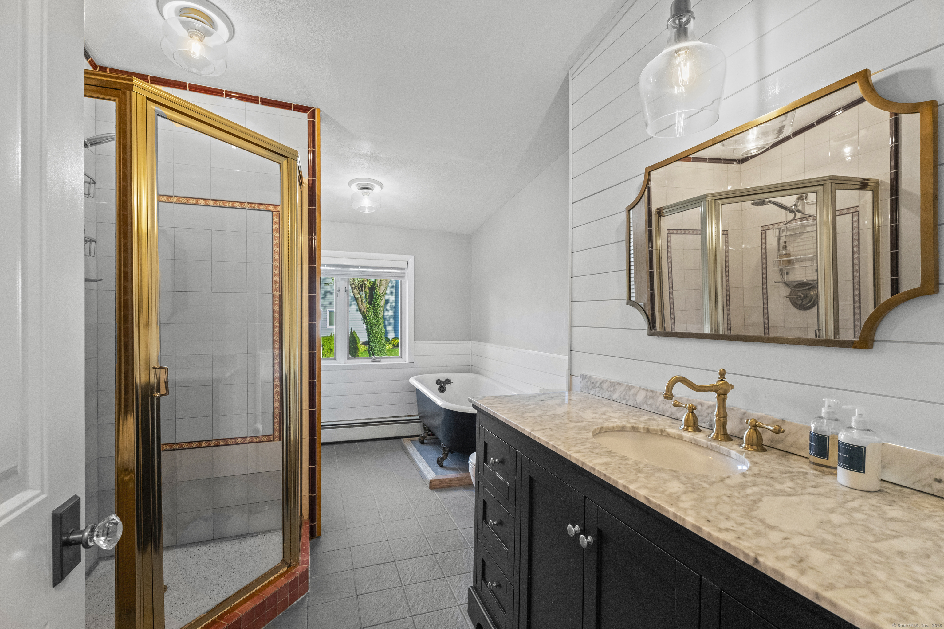 21 Harbor Street Branford, CT 06405 - Photo 28 of 40 a en suite bathroom with a granite countertop sink and a mirror