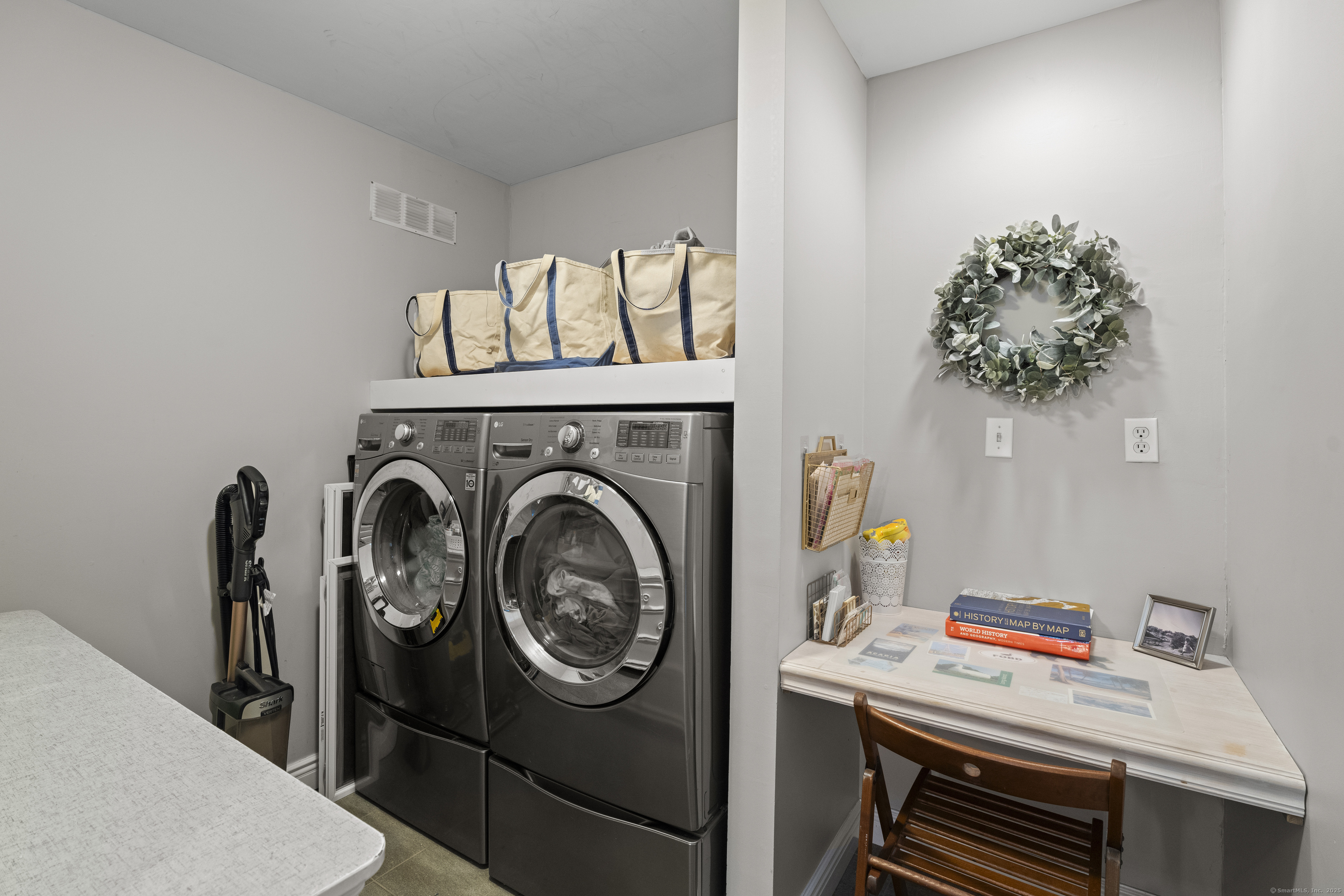 21 Harbor Street Branford, CT 06405 - Photo 31 of 40 a utility room with dryer washer and a view of living room