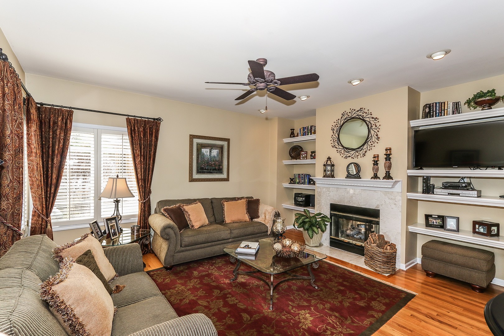 4929 Commonwealth Avenue Western Springs, IL 60558 - Photo 11 of 32 a living room with furniture a fireplace and a flat screen tv