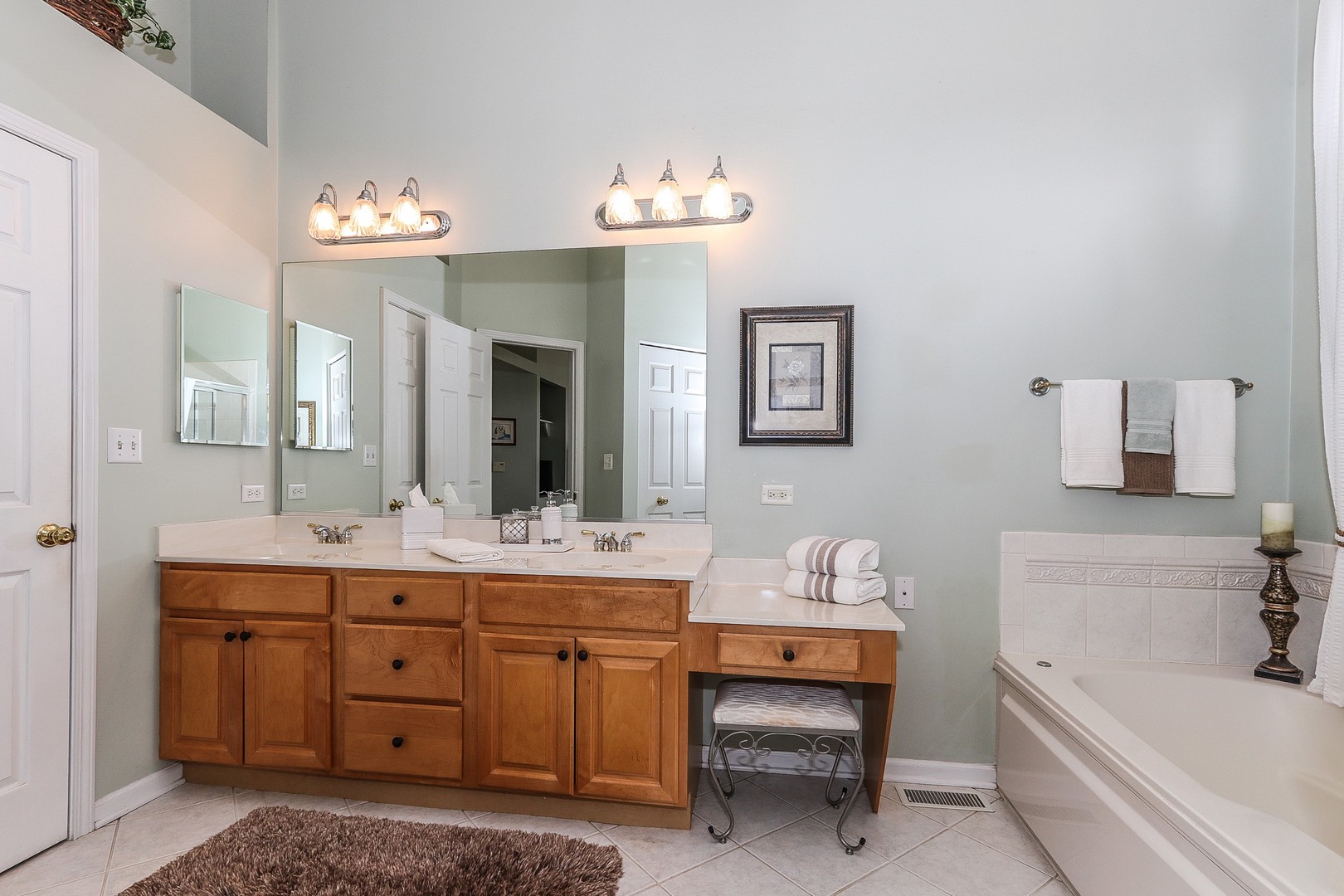 4929 Commonwealth Avenue Western Springs, IL 60558 - Photo 16 of 32 a spacious bathroom with a sink double vanity granite tub and a mirror