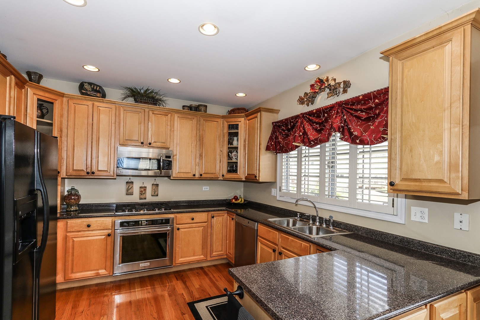 4929 Commonwealth Avenue Western Springs, IL 60558 - Photo 6 of 32 a kitchen with stainless steel appliances granite countertop a stove a sink and a microwave