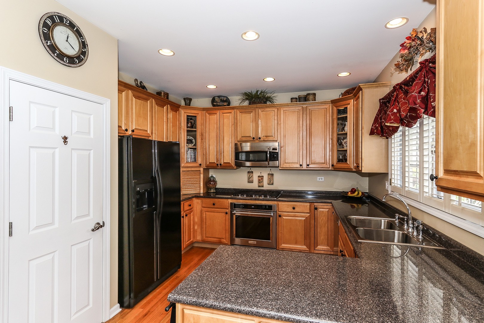 4929 Commonwealth Avenue Western Springs, IL 60558 - Photo 7 of 32 a kitchen with stainless steel appliances granite countertop a refrigerator a sink dishwasher and a stove top oven with wooden floor