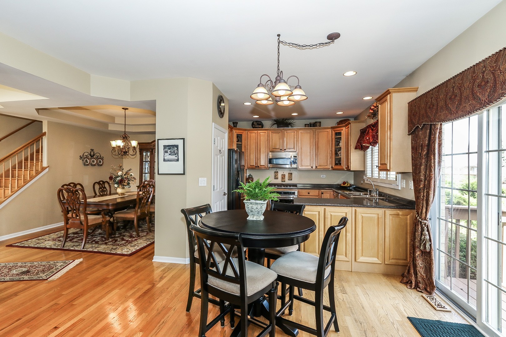4929 Commonwealth Avenue Western Springs, IL 60558 - Photo 8 of 32 a view of a dining room with furniture a chandelier and wooden floor