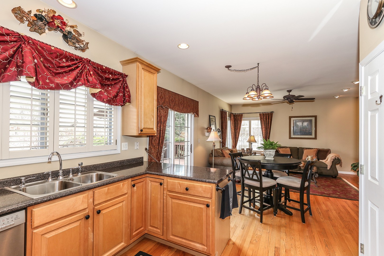4929 Commonwealth Avenue Western Springs, IL 60558 - Photo 9 of 32 a kitchen with stainless steel appliances granite countertop a sink dishwasher a dining table and chairs with wooden floor