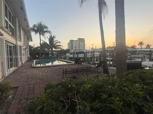 a view of a house with backyard and sitting area
