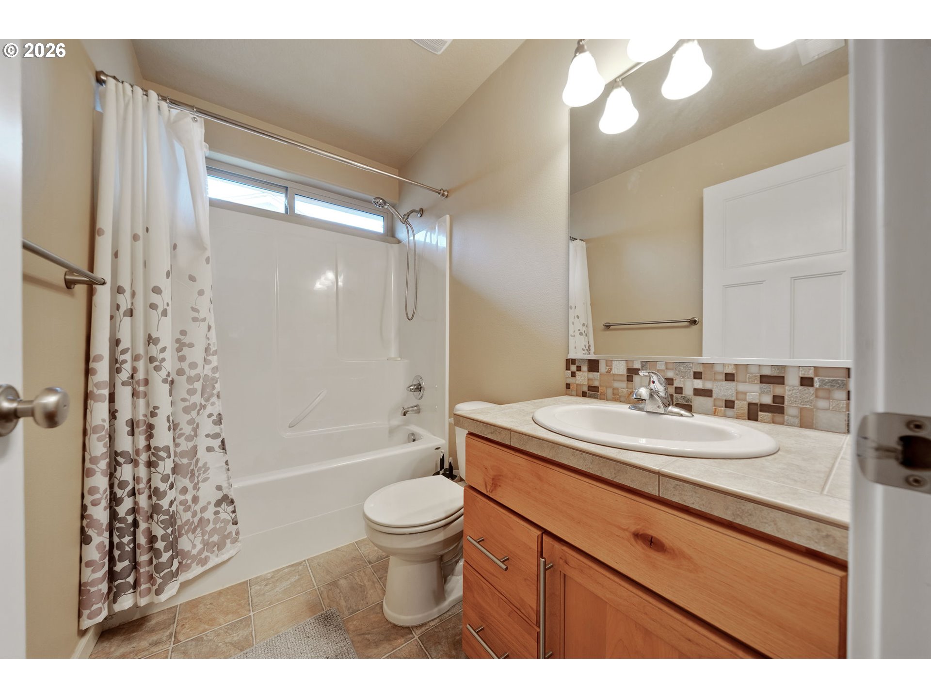 110 Northwest 24th Street Battle Ground, WA 98604 - Photo 12 of 20 a bathroom with a sink toilet a mirror and shower