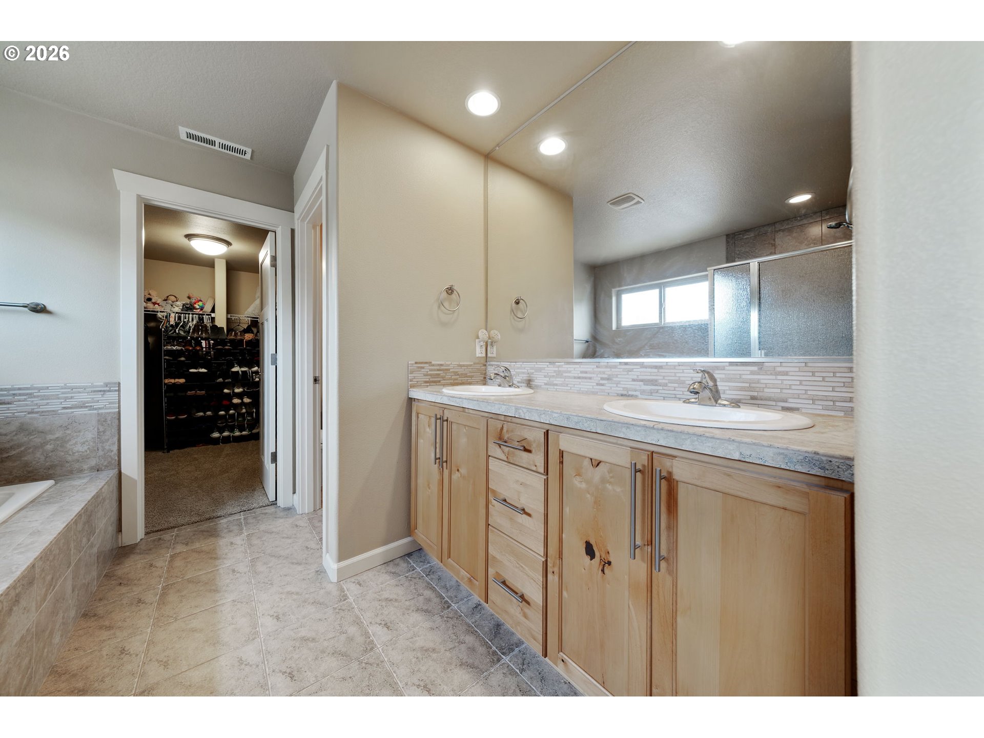 110 Northwest 24th Street Battle Ground, WA 98604 - Photo 14 of 20 a bathroom with a granite countertop sink a mirror and a shower