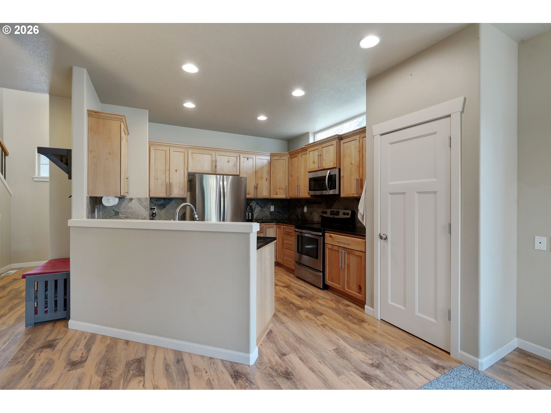 110 Northwest 24th Street Battle Ground, WA 98604 - Photo 5 of 20 a view of kitchen with kitchen island stainless steel appliances sink refrigerator and microwave