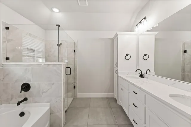a bathroom with a tub sink and mirror