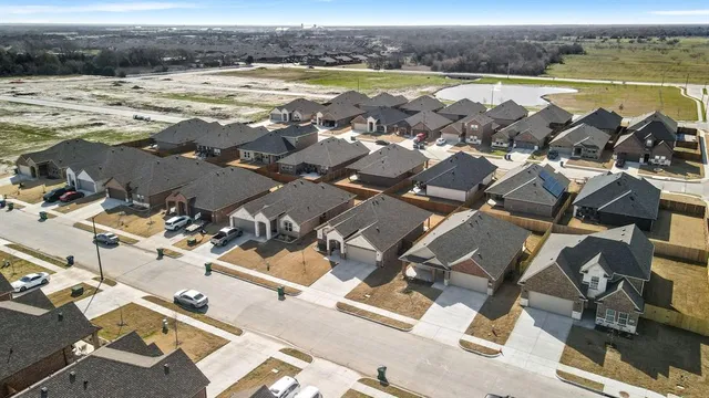 an aerial view of residential building with outdoor space and ocean view