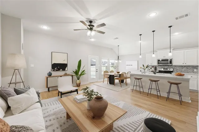 a living room with furniture and kitchen view