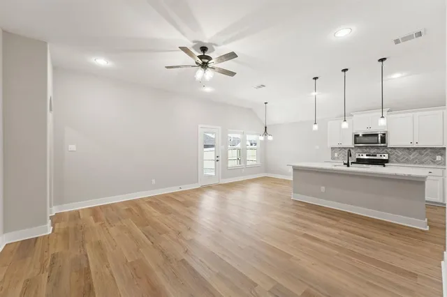 a view of kitchen with cabinets and wooden floor