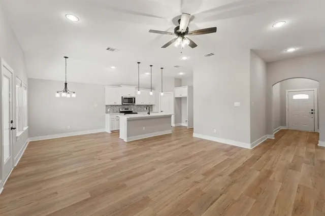 a view of kitchen with granite countertop cabinets and refrigerator
