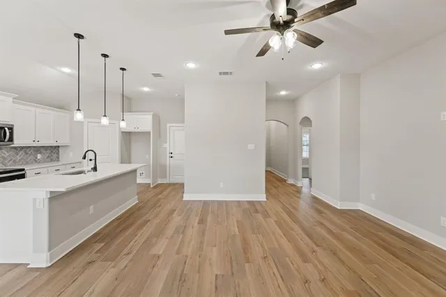 a large kitchen with a hard wood floor