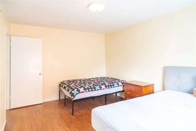 a bedroom with two beds and a potted plant