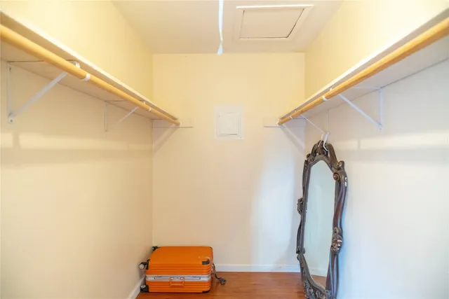 a view of small space with wooden floor and small entryway