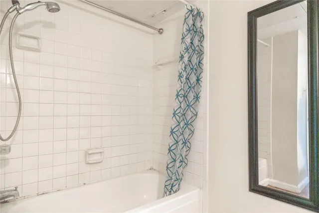 a bathroom with a bathtub and shower