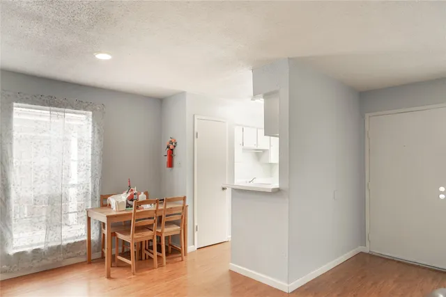a dining room with furniture and wooden floor