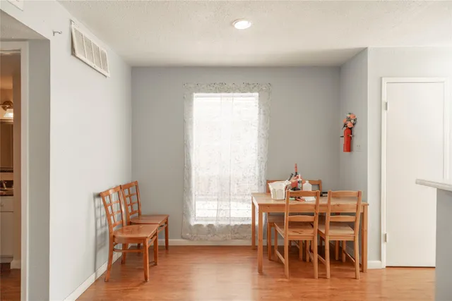 a dining room with furniture and wooden floor