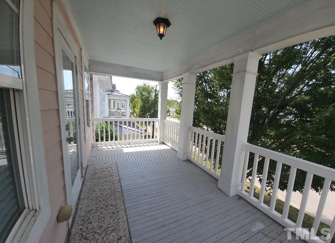 7738 ACC Boulevard Raleigh, NC 27617 - Photo 15 of 17 a view of a porch with wooden floor