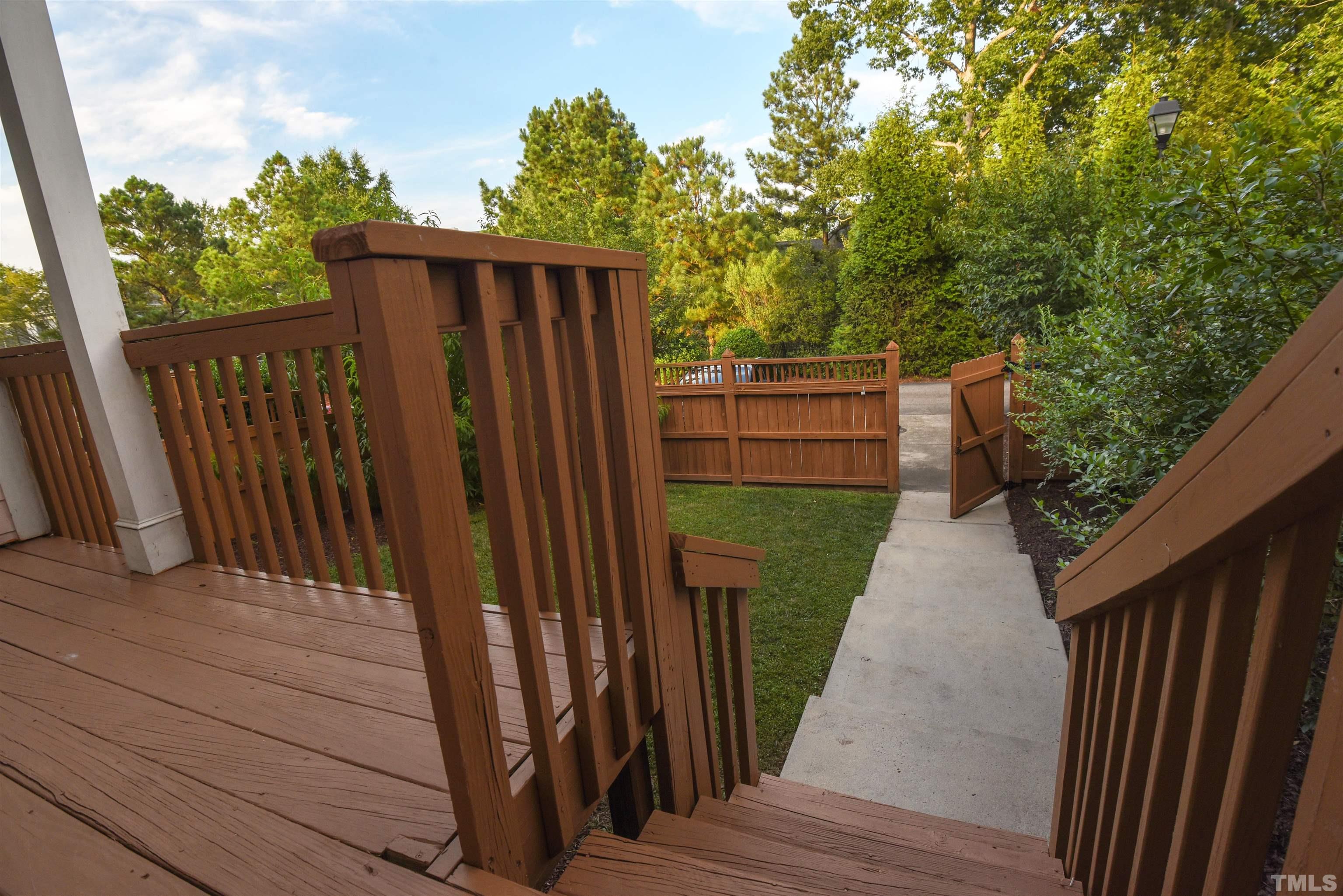 7738 ACC Boulevard Raleigh, NC 27617 - Photo 5 of 17 a view of a backyard with wooden fence