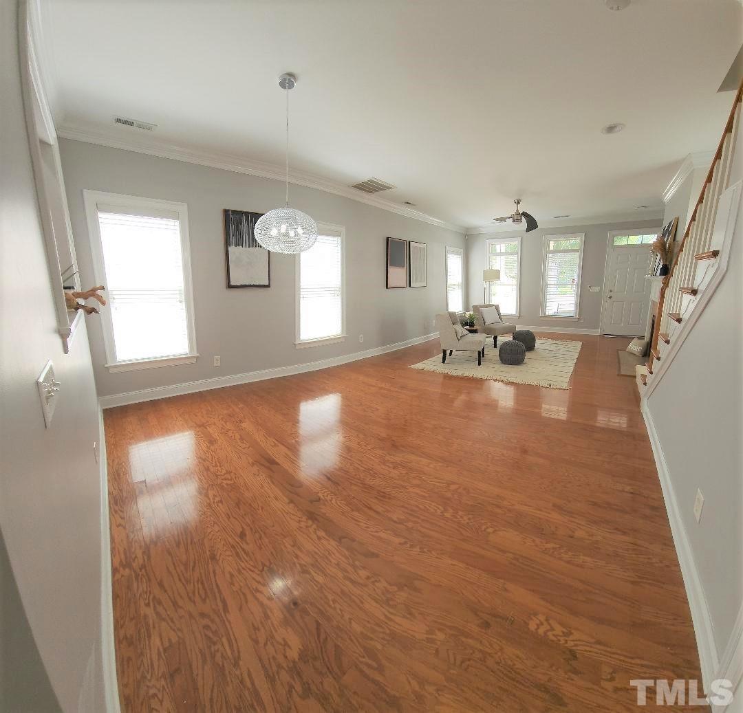 7738 ACC Boulevard Raleigh, NC 27617 - Photo 7 of 17 an empty room with wooden floor and windows
