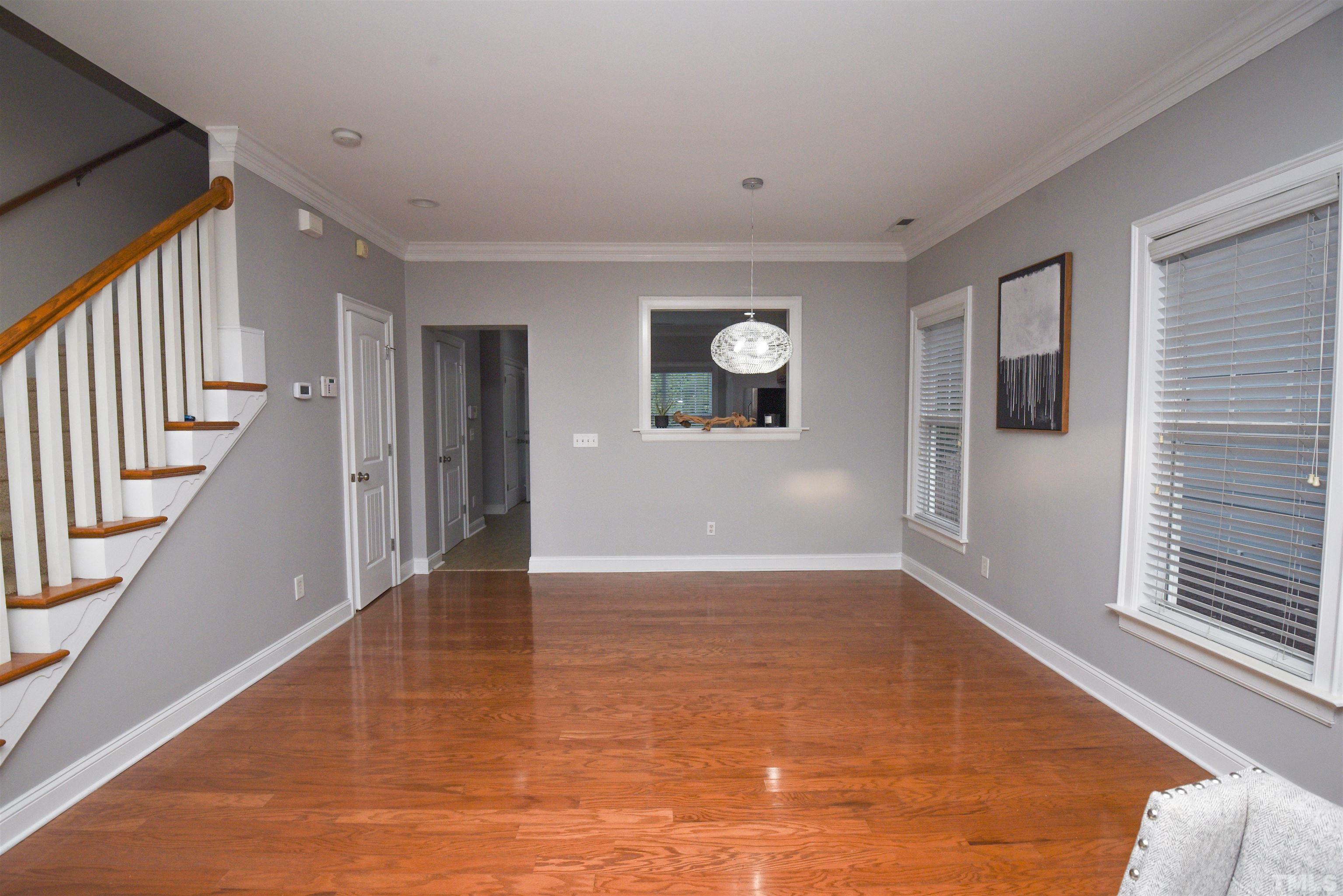 7738 ACC Boulevard Raleigh, NC 27617 - Photo 8 of 17 a view of an empty room with wooden floor and a window
