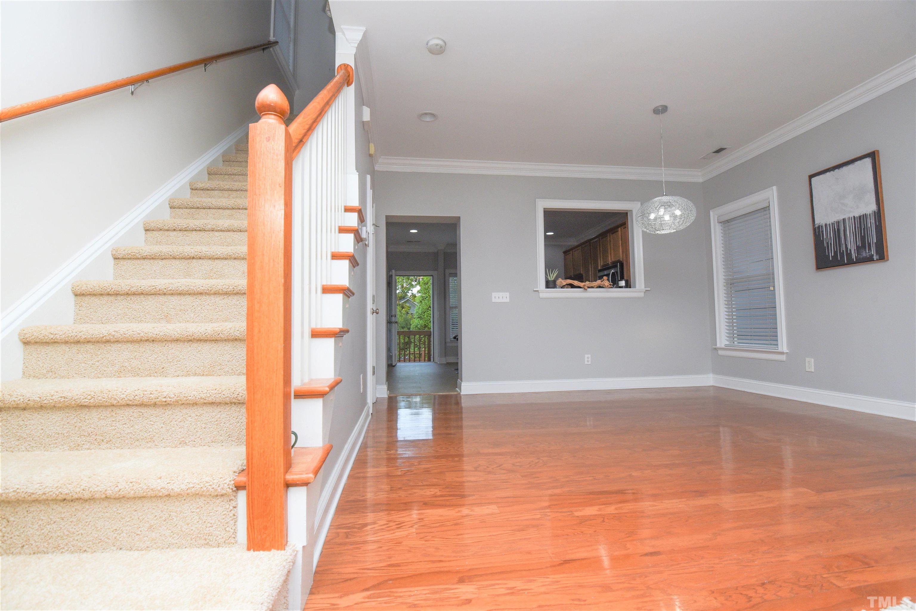 7738 ACC Boulevard Raleigh, NC 27617 - Photo 10 of 17 a view of an entryway with wooden floor and windows