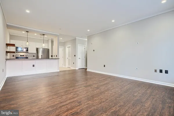 a view of a kitchen with a sink and wooden floor