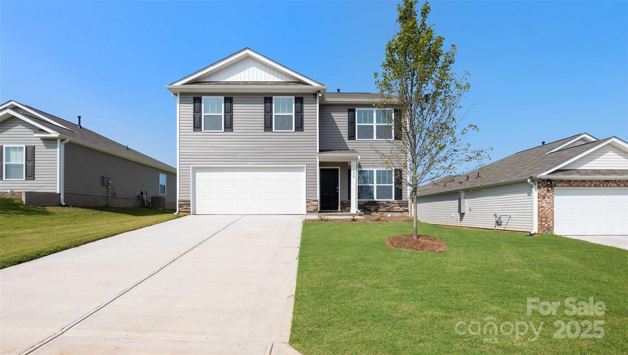 205 Callie River Clyde, NC 28721 - Photo 2 of 20 a front view of a house with a yard and garage