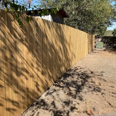 a view of small space with wooden fence