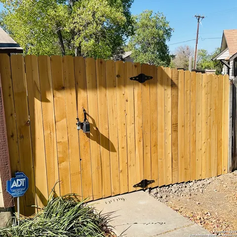 a view of a house with a door and wooden bench