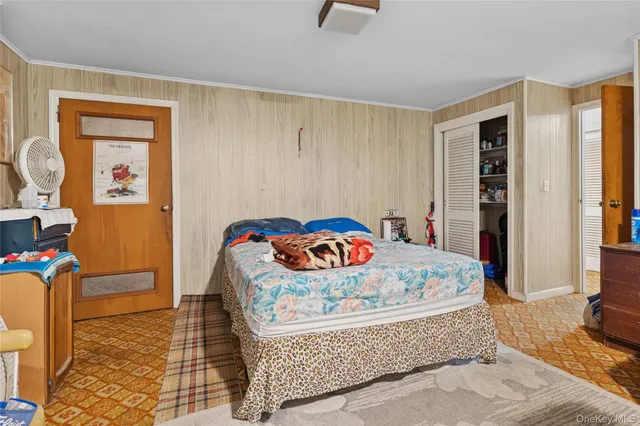 a bedroom with a bed couch and window