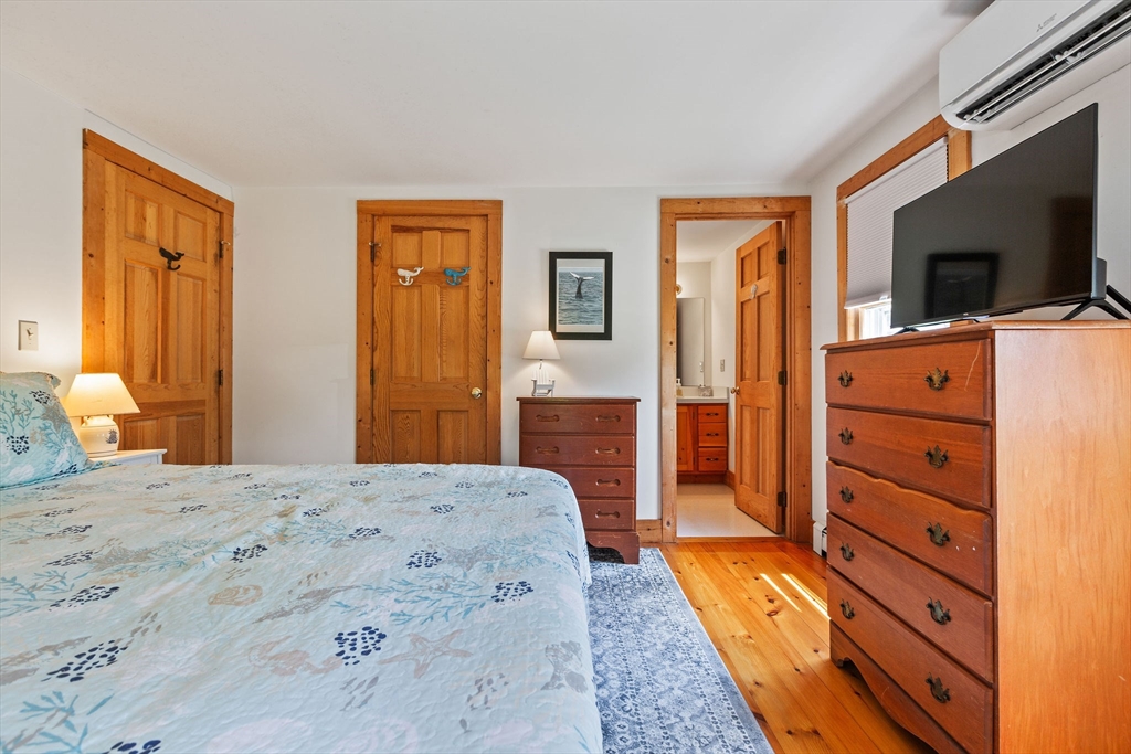 64 Beaten Road Dennis, MA 02639 - Photo 13 of 18 a bedroom with a bed and a flat tv screen in it