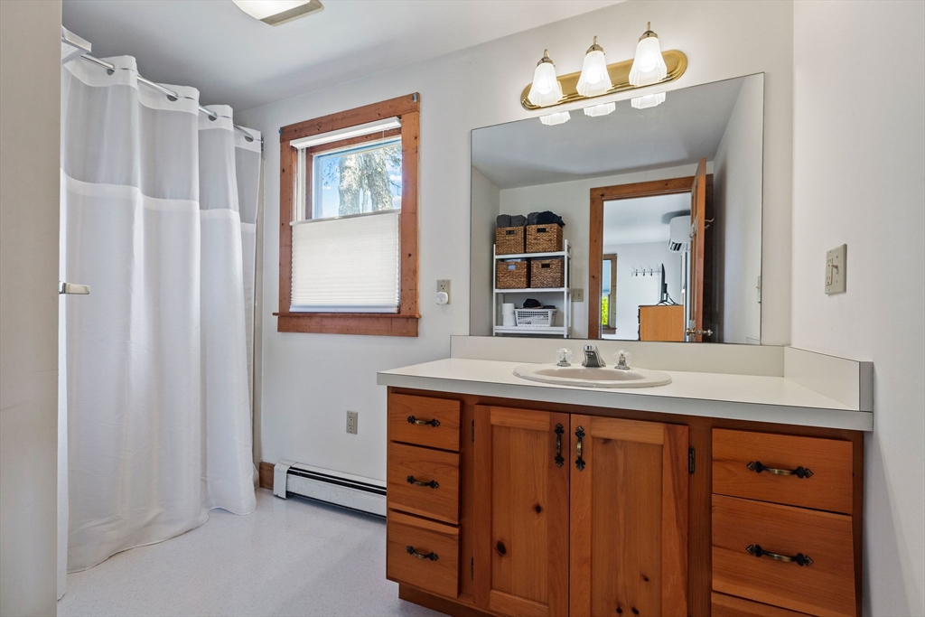 64 Beaten Road Dennis, MA 02639 - Photo 14 of 18 a bathroom with a double vanity sink and a mirror