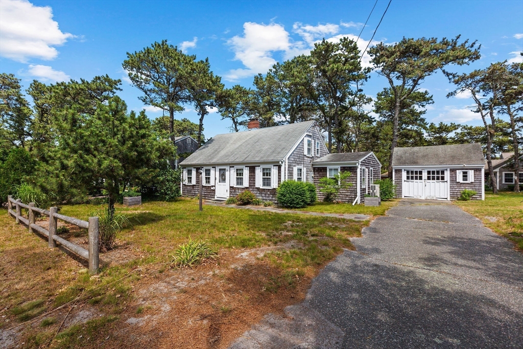 64 Beaten Road Dennis, MA 02639 - Photo 2 of 18 a front view of a house with a garden