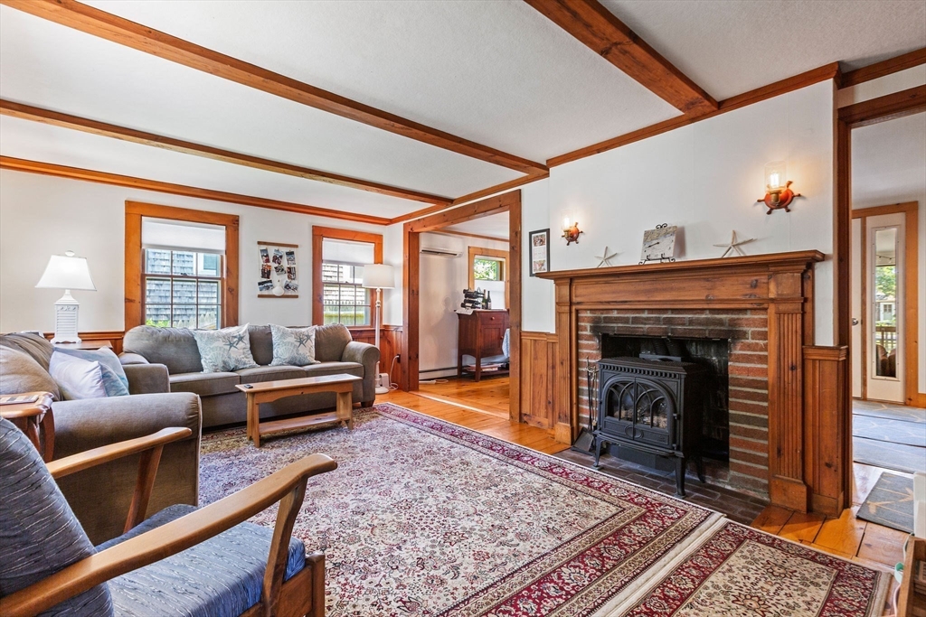 64 Beaten Road Dennis, MA 02639 - Photo 5 of 18 a living room with furniture and a fireplace