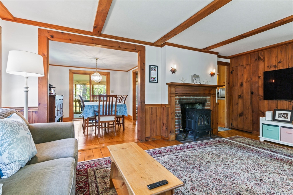 64 Beaten Road Dennis, MA 02639 - Photo 8 of 18 a living room with furniture a fireplace and a flat screen tv