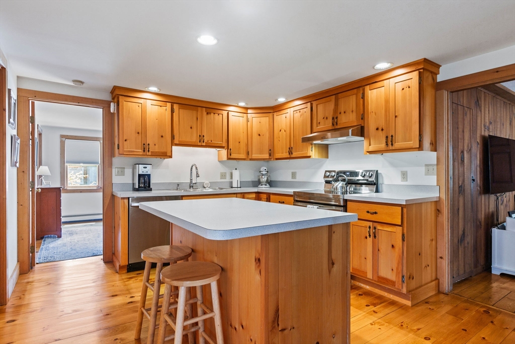 64 Beaten Road Dennis, MA 02639 - Photo 10 of 18 a kitchen with stainless steel appliances granite countertop a sink stove and refrigerator