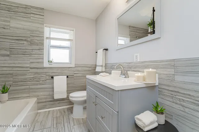 a bathroom with a sink toilet and vanity