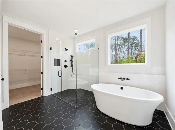 a bathroom with a double vanity sink a toilet and shower
